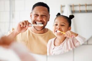 Parent and child with healthy teeth in Riverside, CA
