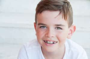 Boy with bright smile after fluoride treatment in Riverside, CA