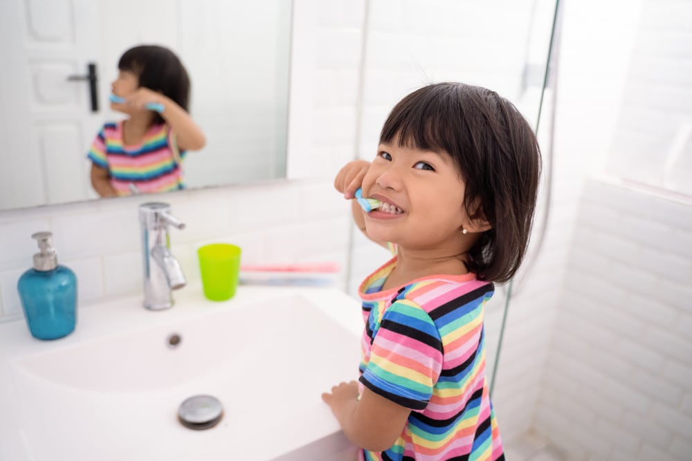 Child brushing teeth to prevent cavities in Corona, CA