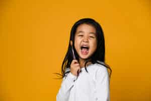 Child with healthy smile after cavity repair in Riverside, CA