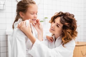 Mom helping child establish good dental habits in Riverside, CA